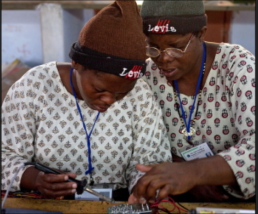 Women working on solar lighting circuit boards.